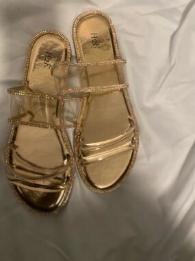 Gold sandals trimmed in gold stones